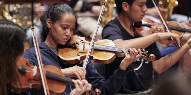 Junior Guildhall strings students performing on stage