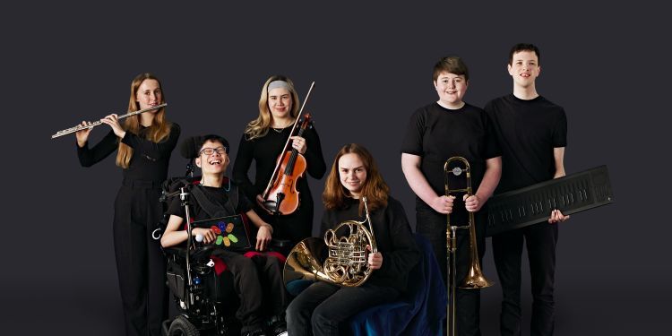 National Open Youth Orchestra musicians holding instruments in front of black background