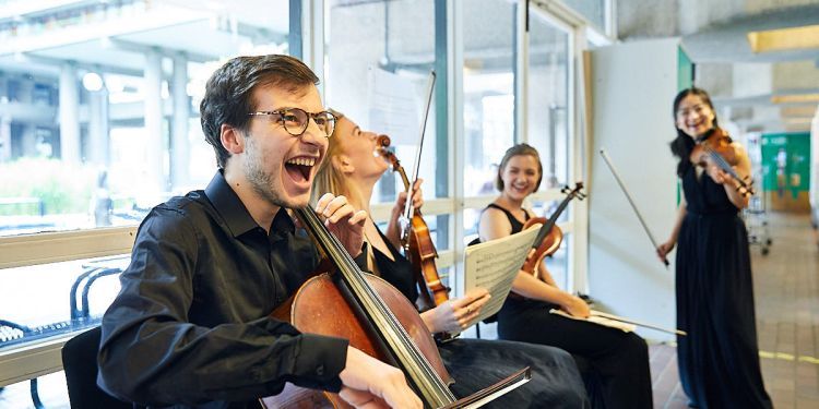 String students laughing back stage