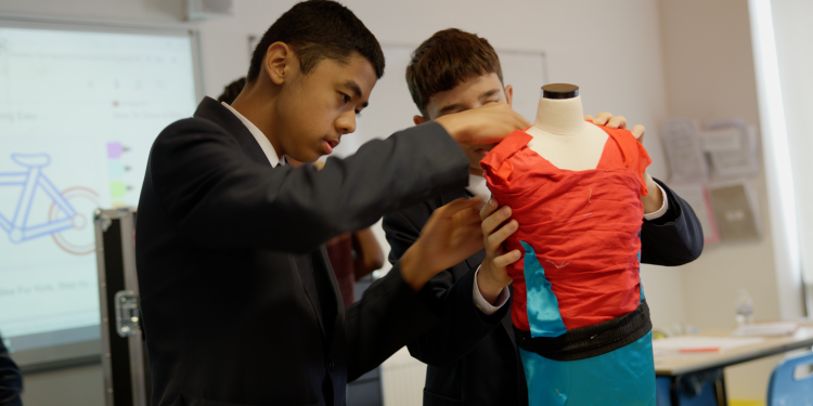 Students working on costume mannequin
