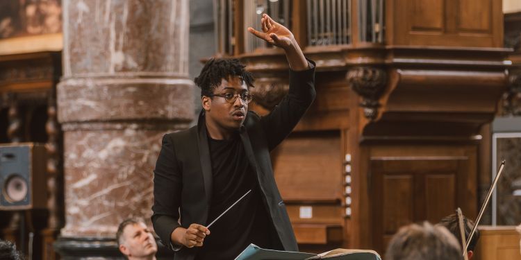 Enyi Okpara conducting the London Schools Symphony Orchestra in Belgium