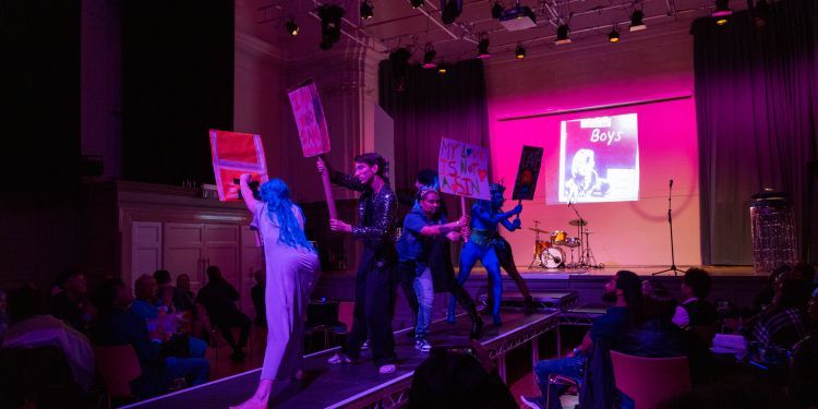 artists stand on a stage