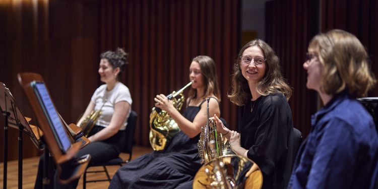 Brass students during a rehearsal on stage