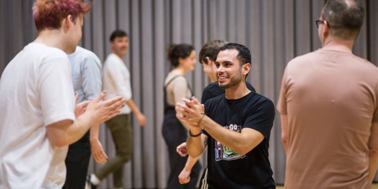 people standing and laughing in a room