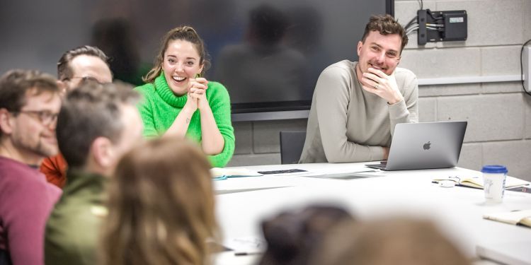 people sitting around at a table and smiling
