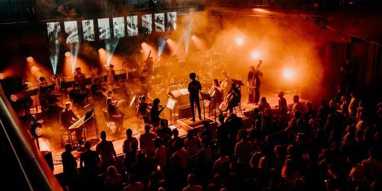 OrchestRAM concert with orchestra on stage with conductor