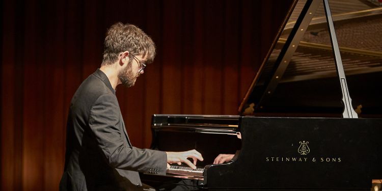 William Bracken performing on the piano on stage 