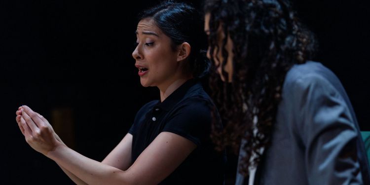 Two vocal students on stage singing