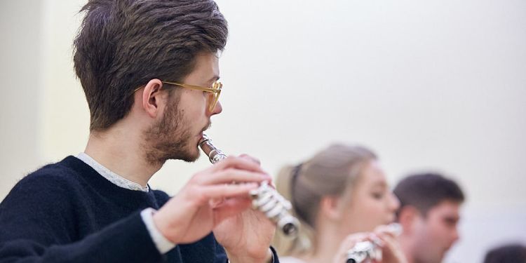 Close up shot of a student playing flute