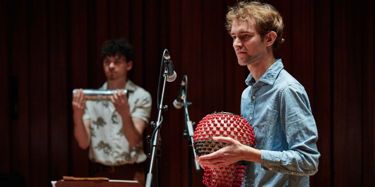 Students playing percussion instruments on stage