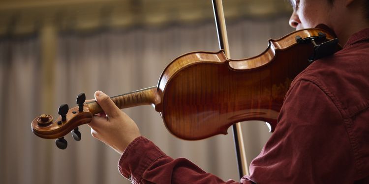 Close up shot of student playing violin