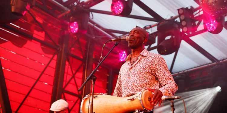 SOLA AKINGBOLA performing percussion on stage