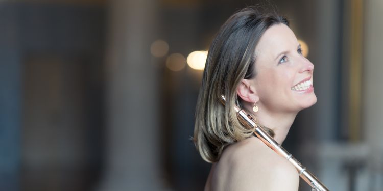 Steffi Winker smiling holding her flute wearing an evening gown