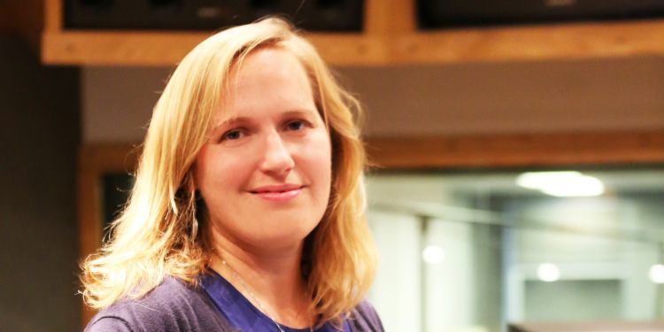 Headshot of Amy Blier-Carruthers standing next to a sound desk