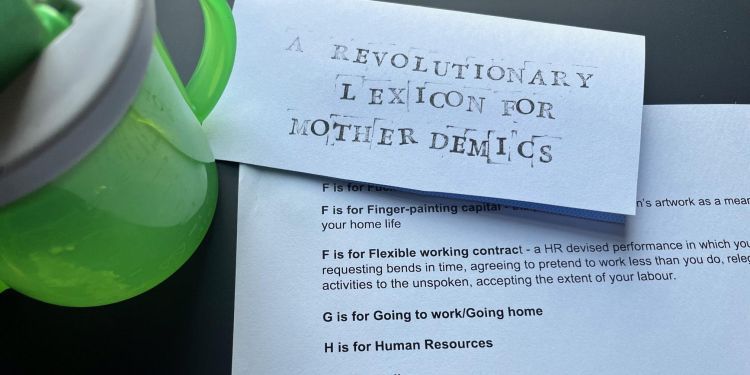A baby sip cup next to a piece of paper that says "A revolutionary lexicon for mother demics"