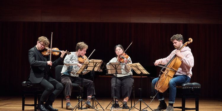 4 musicians sat on stage as part of a chamber group in the Guildhall School Chamber Music Festival 2025