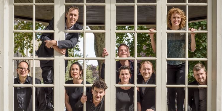 EXAUDI Vocal Ensemble pictured behind a square grid