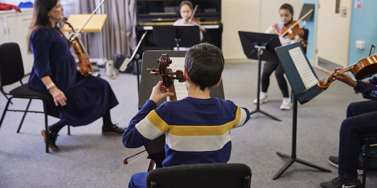 Students playing string instruments