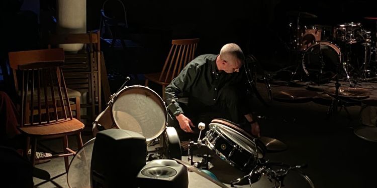 Paul Abbott setting up a drum kit