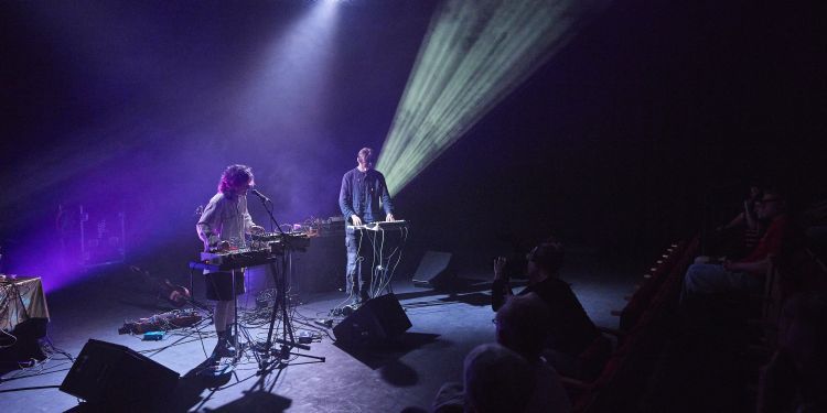 Electronic and Produced Music Students performing on stage with a purple hue lighting