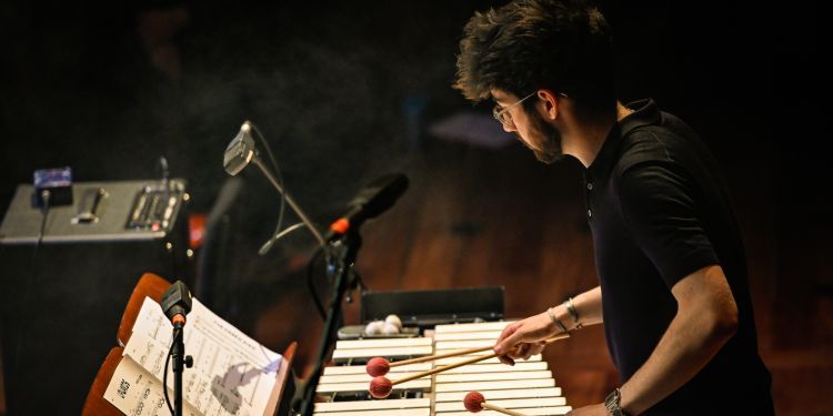 Percussion student on stage playing the xylophone