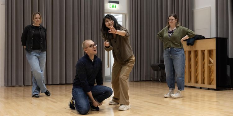 Two participants performing while others look on