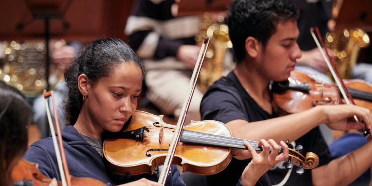 young people playing violin together