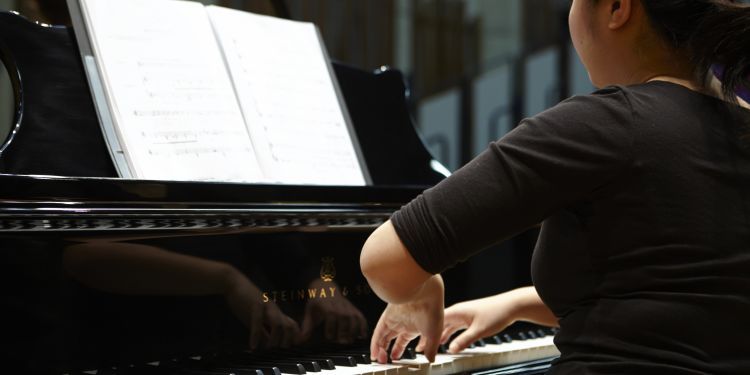 The back of a pianist playing 