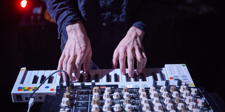 Close up shot of a students hands using a sound desk