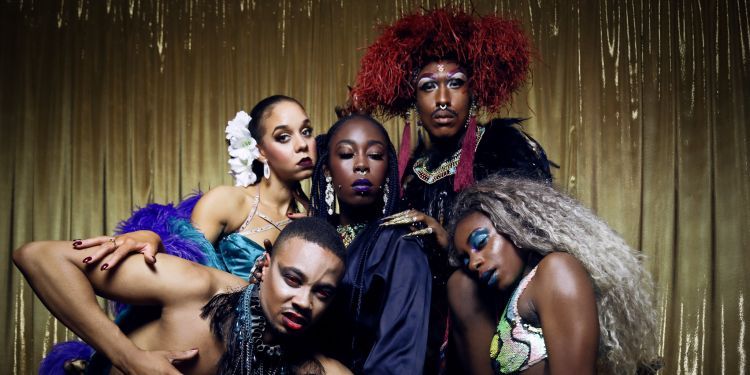 5 dancers leaning on top of one another at the Cocoa Butter Cabaret Club