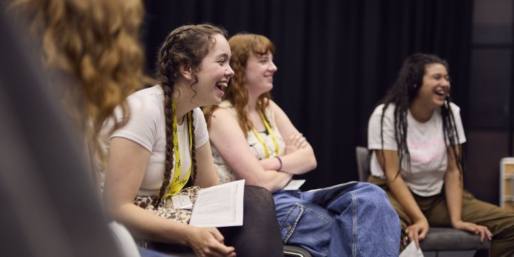 Course participants sitting down and laughing together 