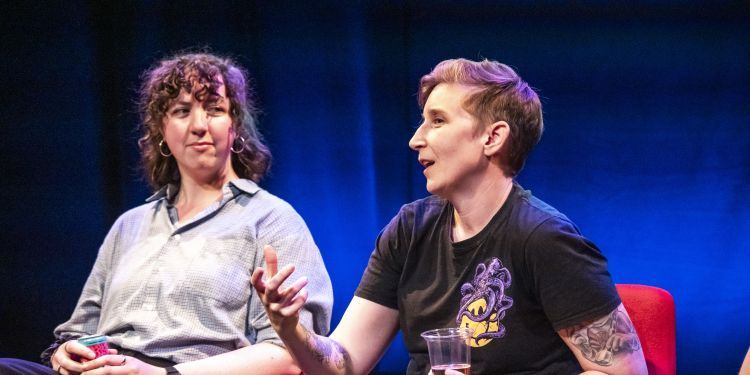 Students and professors on stage sat in chairs during a Making It Work panel discussion