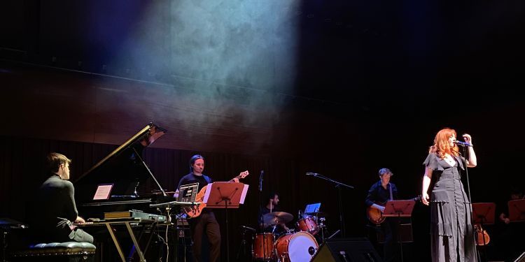 Musicians on stage in dramatic lighting