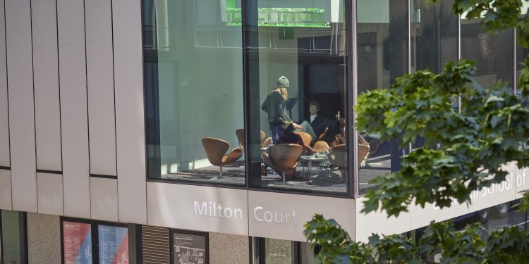 Exterior of Milton Court with students sat in the window