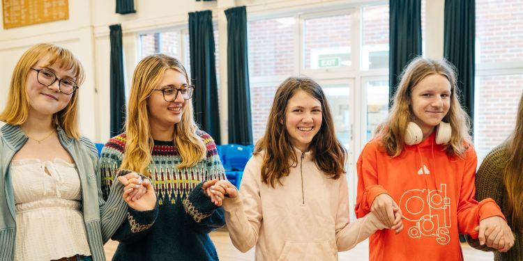 GYA Norwich students smiling and holding hands