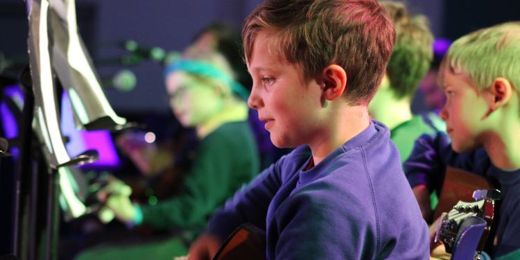 Guitar students from music education islington performing on stage