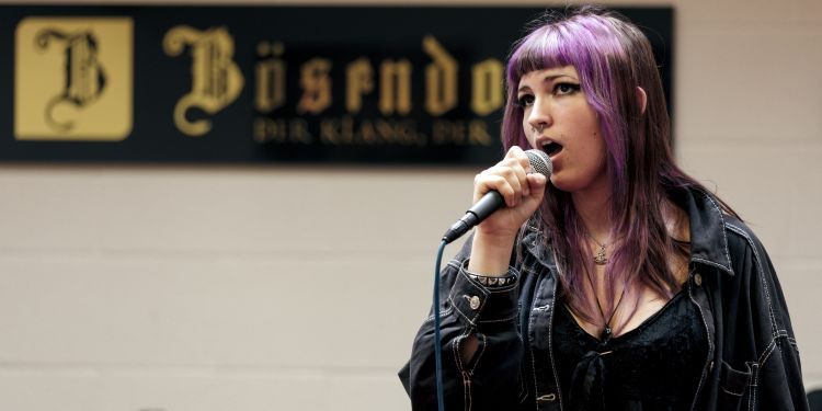 GYA Taunton student singing holding microphone