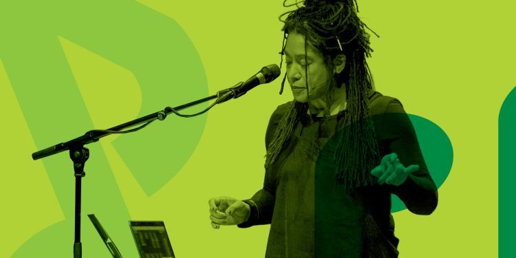 Green background with Elaine Mitchener looking at a microphone