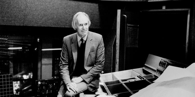 Man sitting in recording studio in a suit 