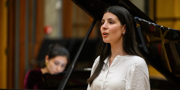 Vocal student singing stood in front of a pianist 