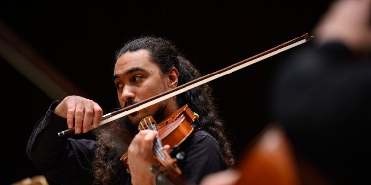 Violin student on stage performing