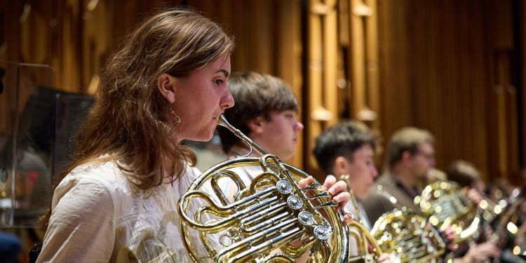 Guildhall Symphonic Wind Orchestra on stage performing 