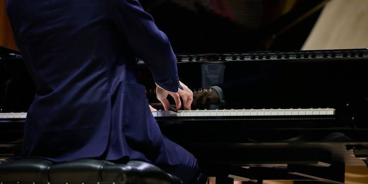 Man sitting and playing the piano 