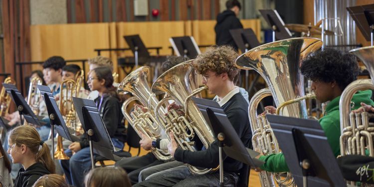 Junior Guildhall Brass Band students performing on stage