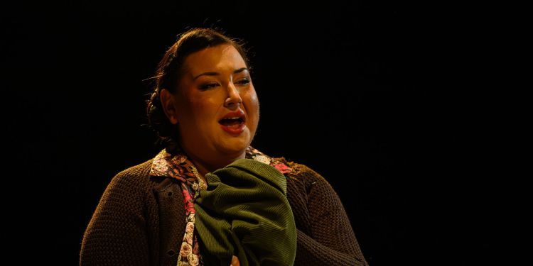 Female opera singer holding a sweater and singing