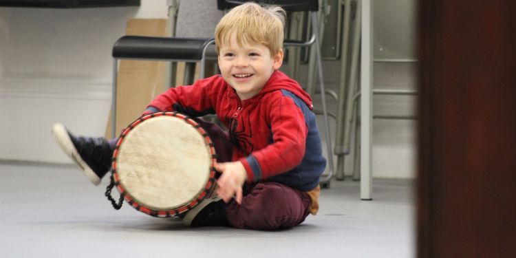 Image of a boy playing a drum 
