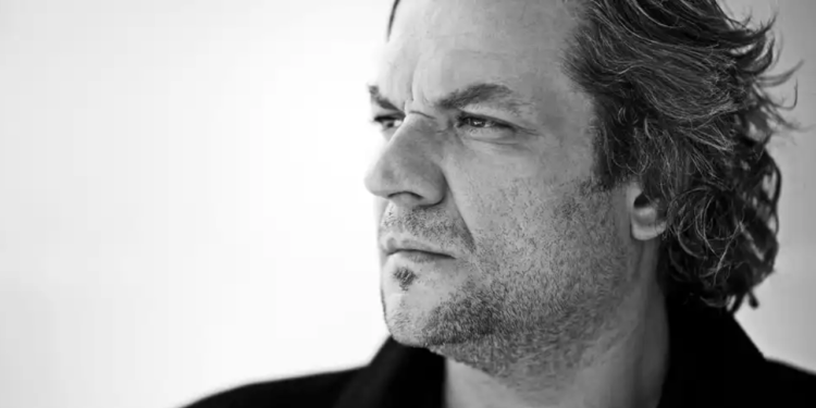 Black and white headshot of Željko Lučić looking away from the camera