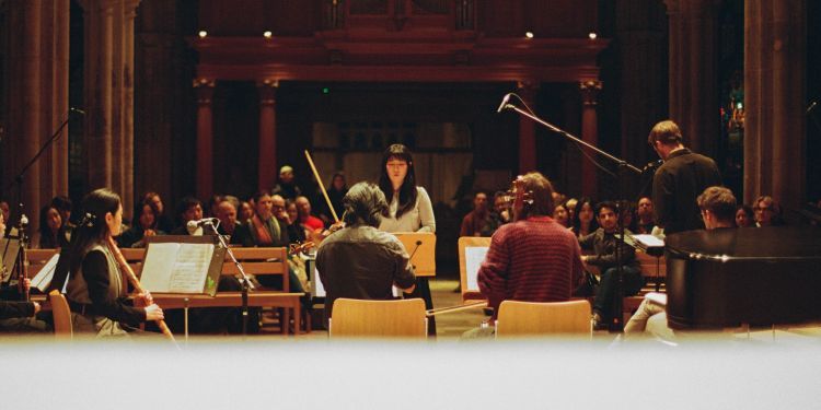 Sohee Baek conducting an orchestra