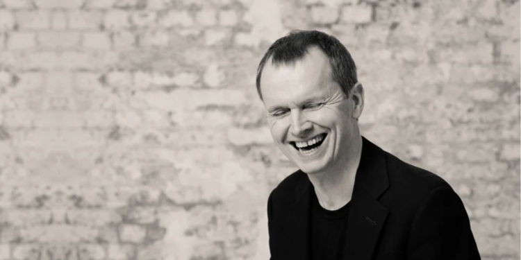 Black and white headshot of Steven Osborne laughing -credit Ben Ealovega