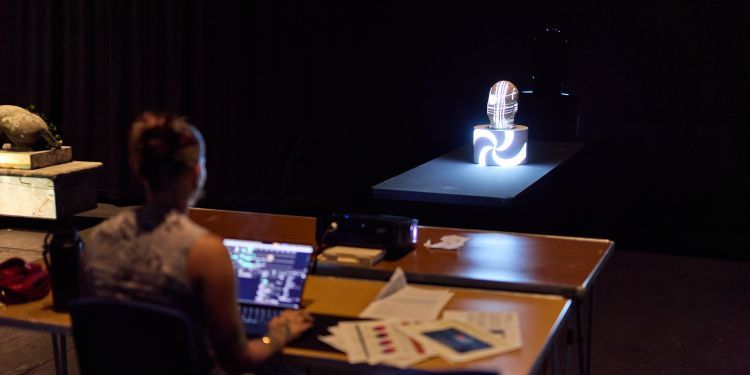 A woman projects her work onto an object